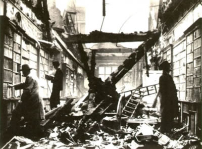 picture of men browsing a library amidst wreckage from recent bombing